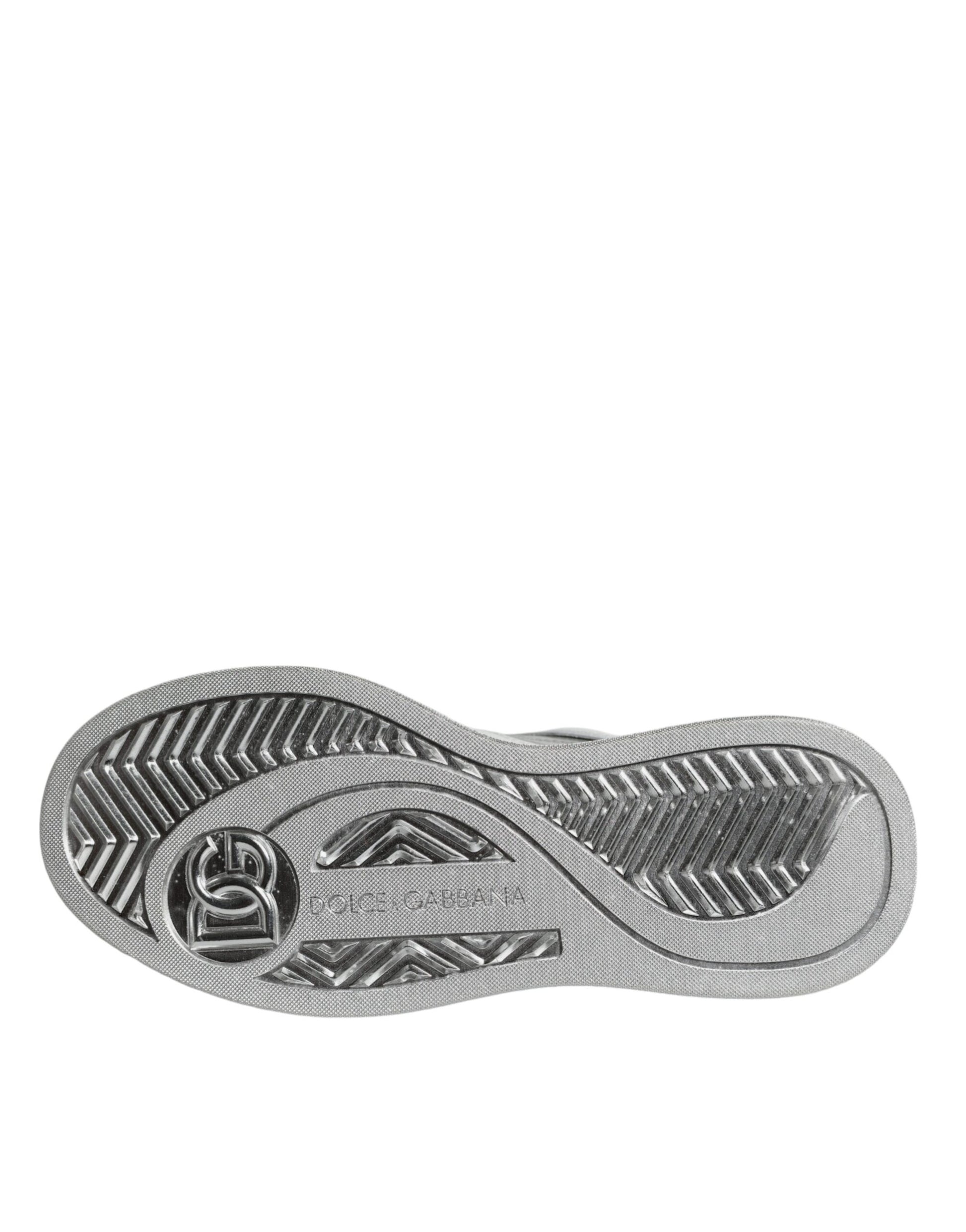 A pair of white silver leather low top sneakers with a logo on the side