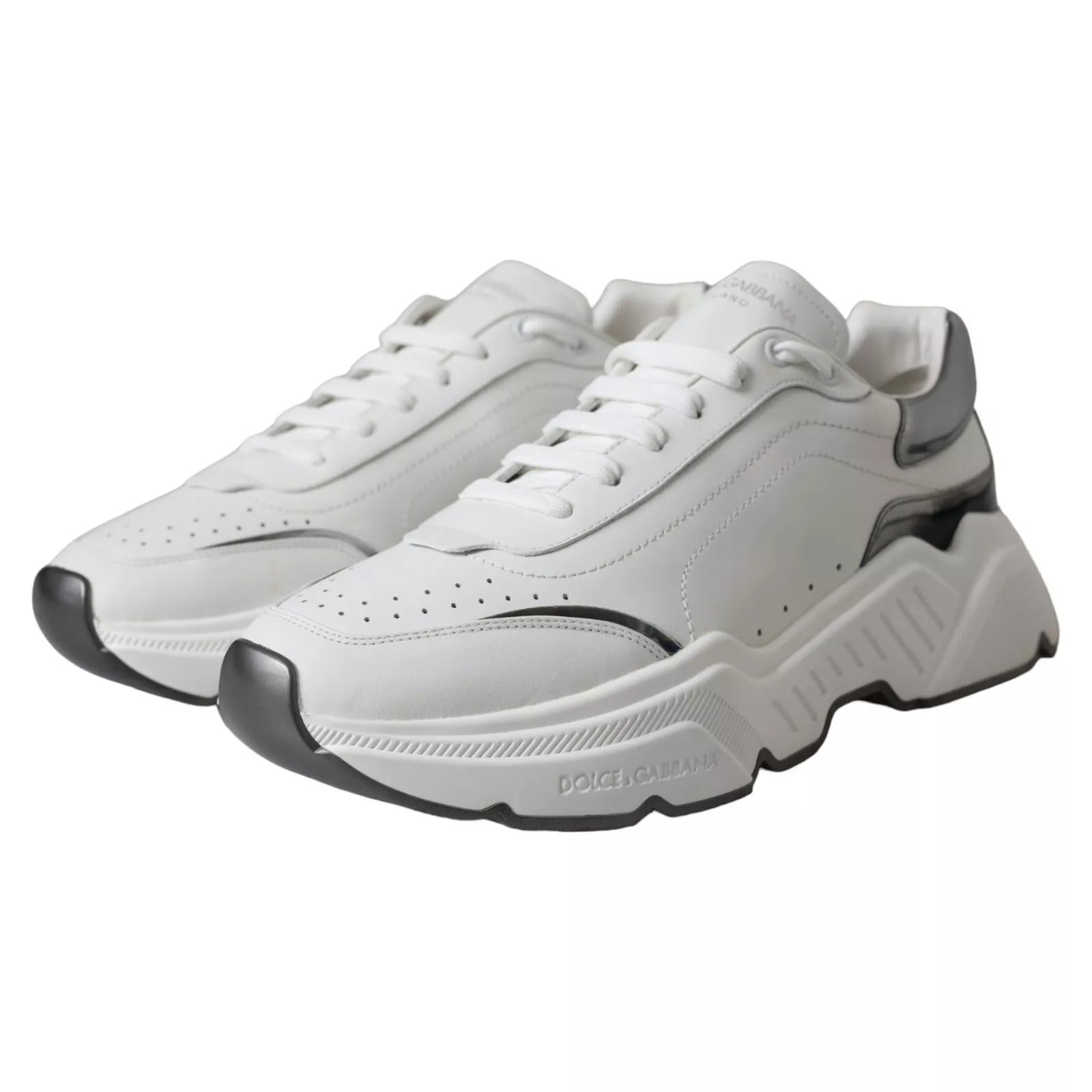 White leather sneakers with silver accents, featuring a low-top design and a chunky sole