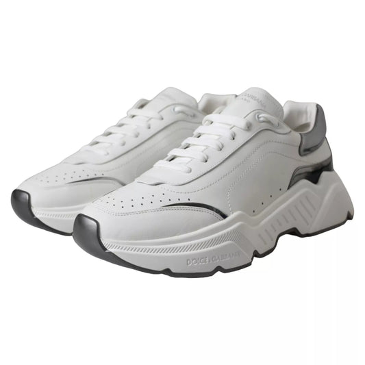 White leather sneakers with silver accents, featuring a low-top design and a chunky sole