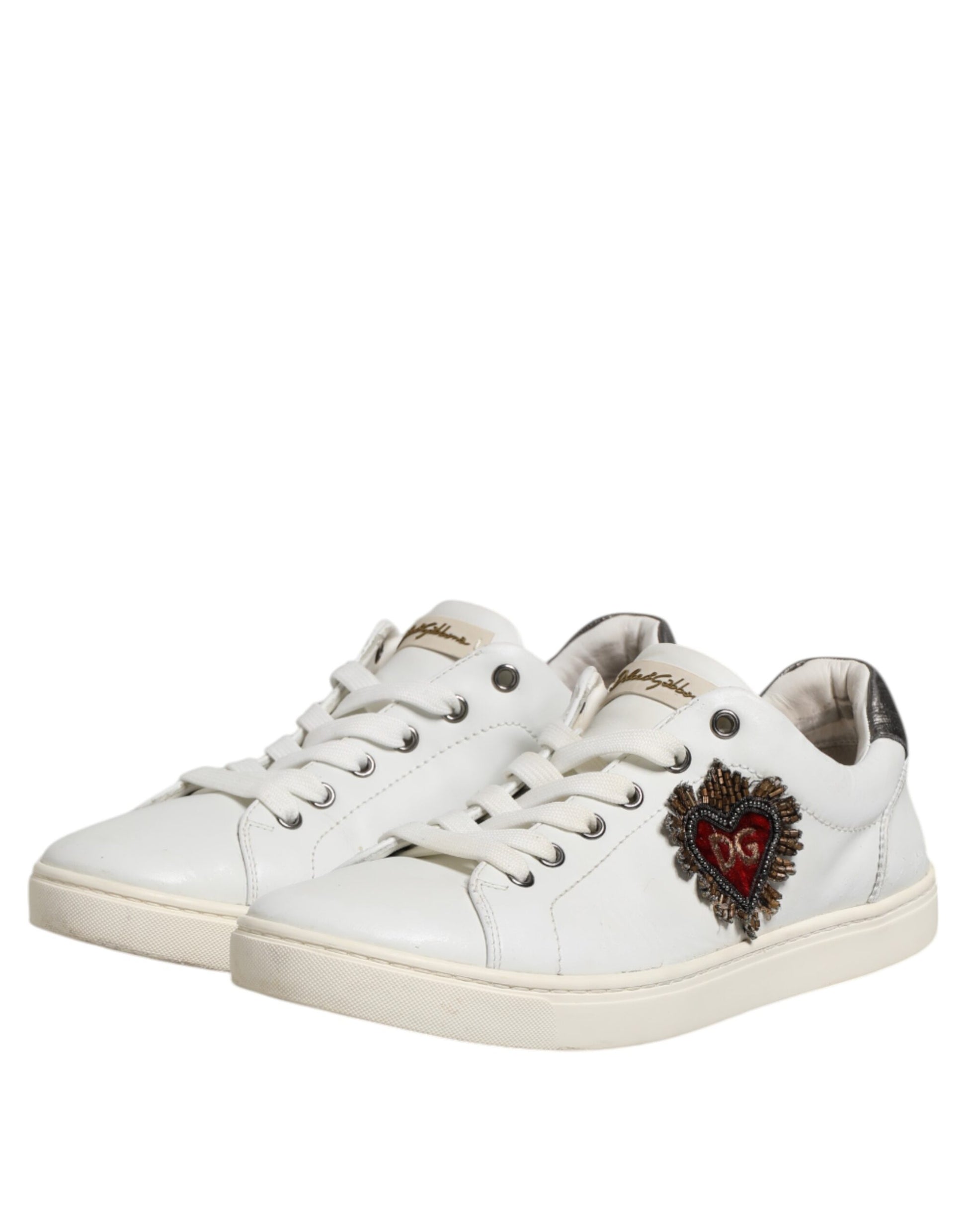 White sneakers with silver laces, featuring a heart design on the side