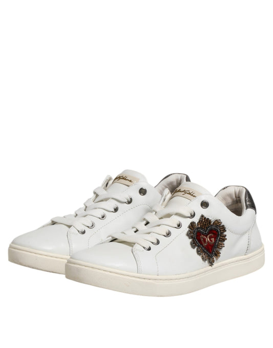 White sneakers with silver laces, featuring a heart design on the side