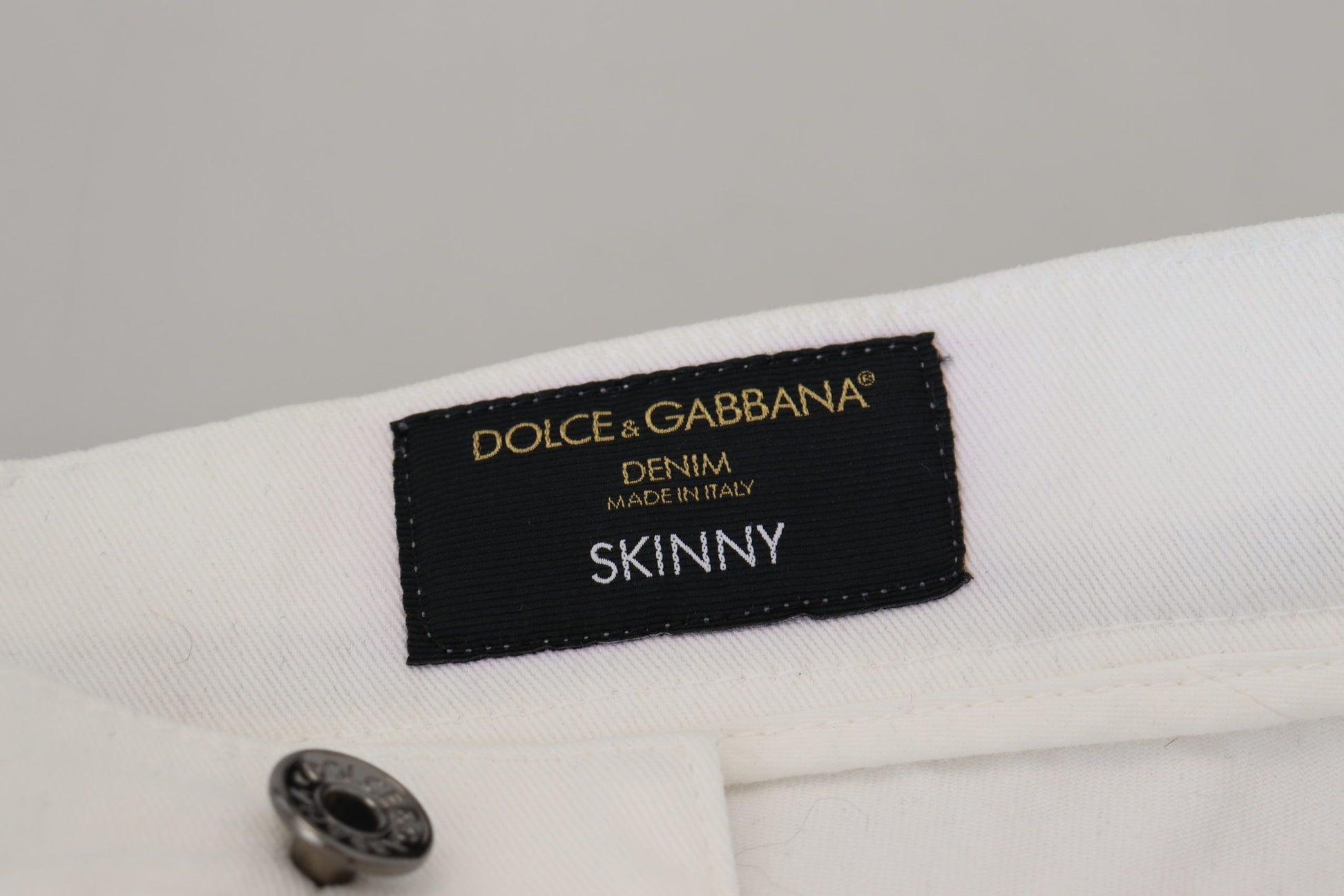 Tag on a garment reading "Dolce & Gabbana SINNY"