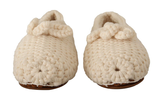 Pair of crocheted baby booties with tassels and pom poms