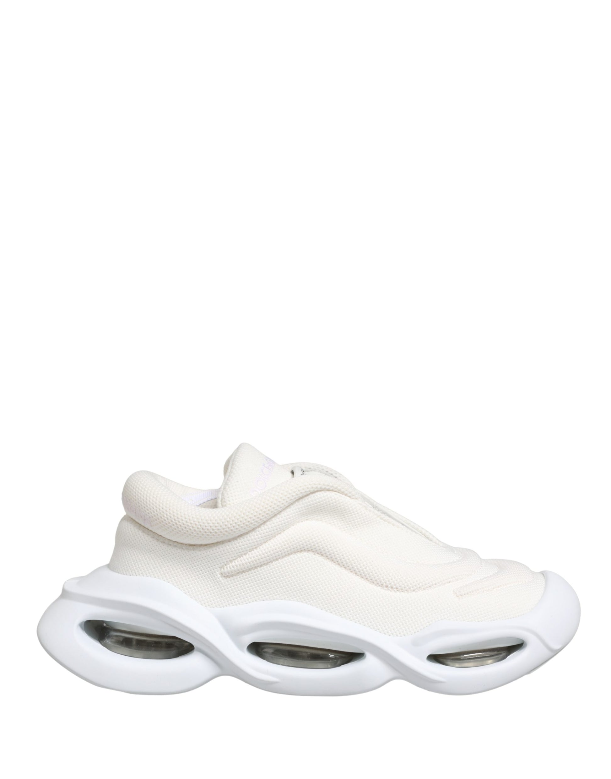 A pair of white slip-on shoes with a low top, featuring a wave design on the side