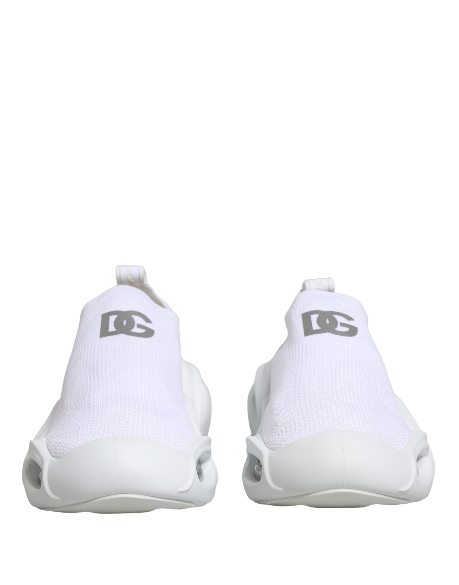 Pair of white slip-on shoes with logo on side, featuring a low top and wavy design