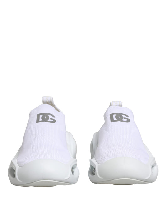 Pair of white slip-on shoes with logo on side, featuring a low top and wavy design