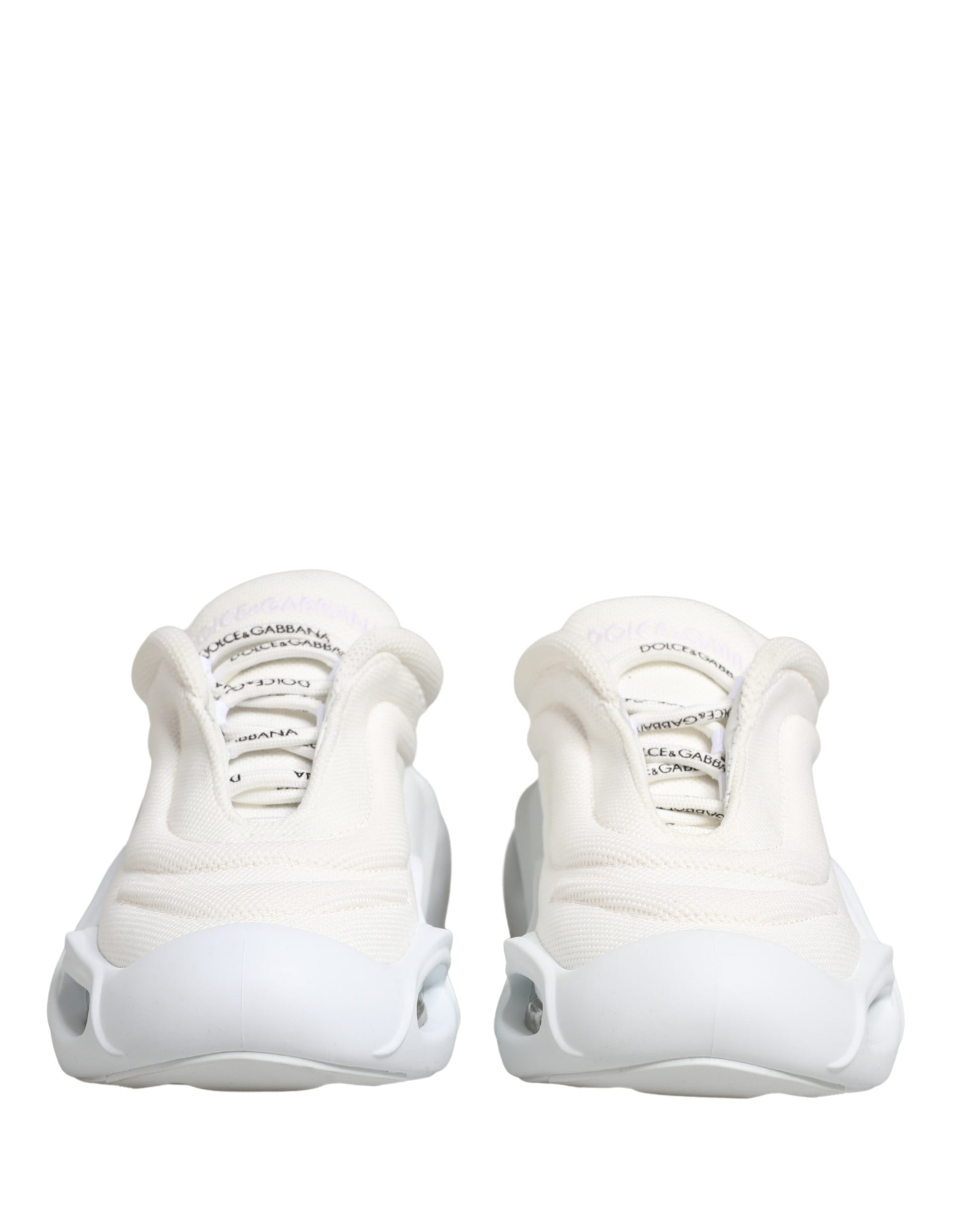 Pair of white slip-on shoes with embossed logo and textured design