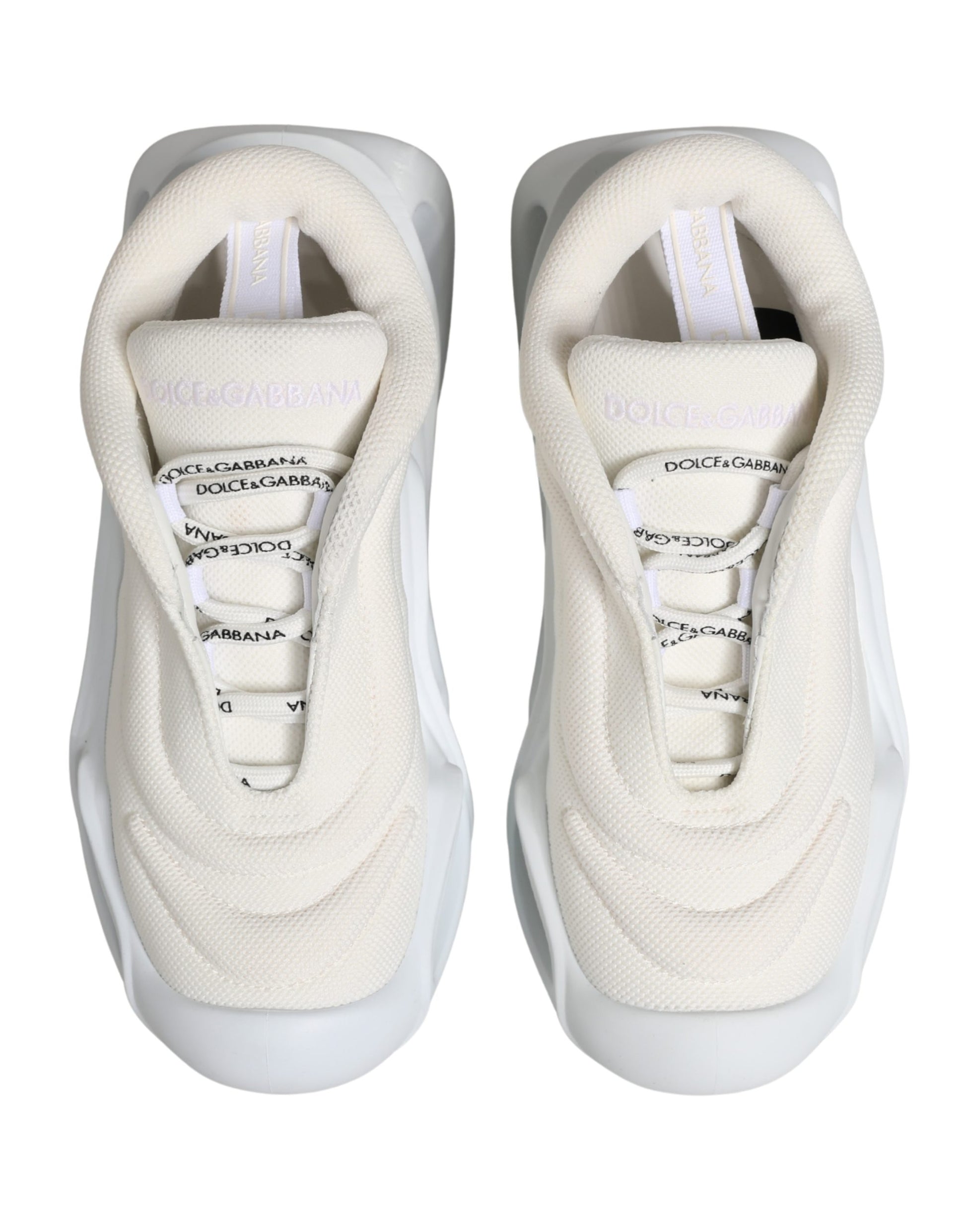 Pair of white slip-on shoes with laces, featuring a low top and a wave design on the side