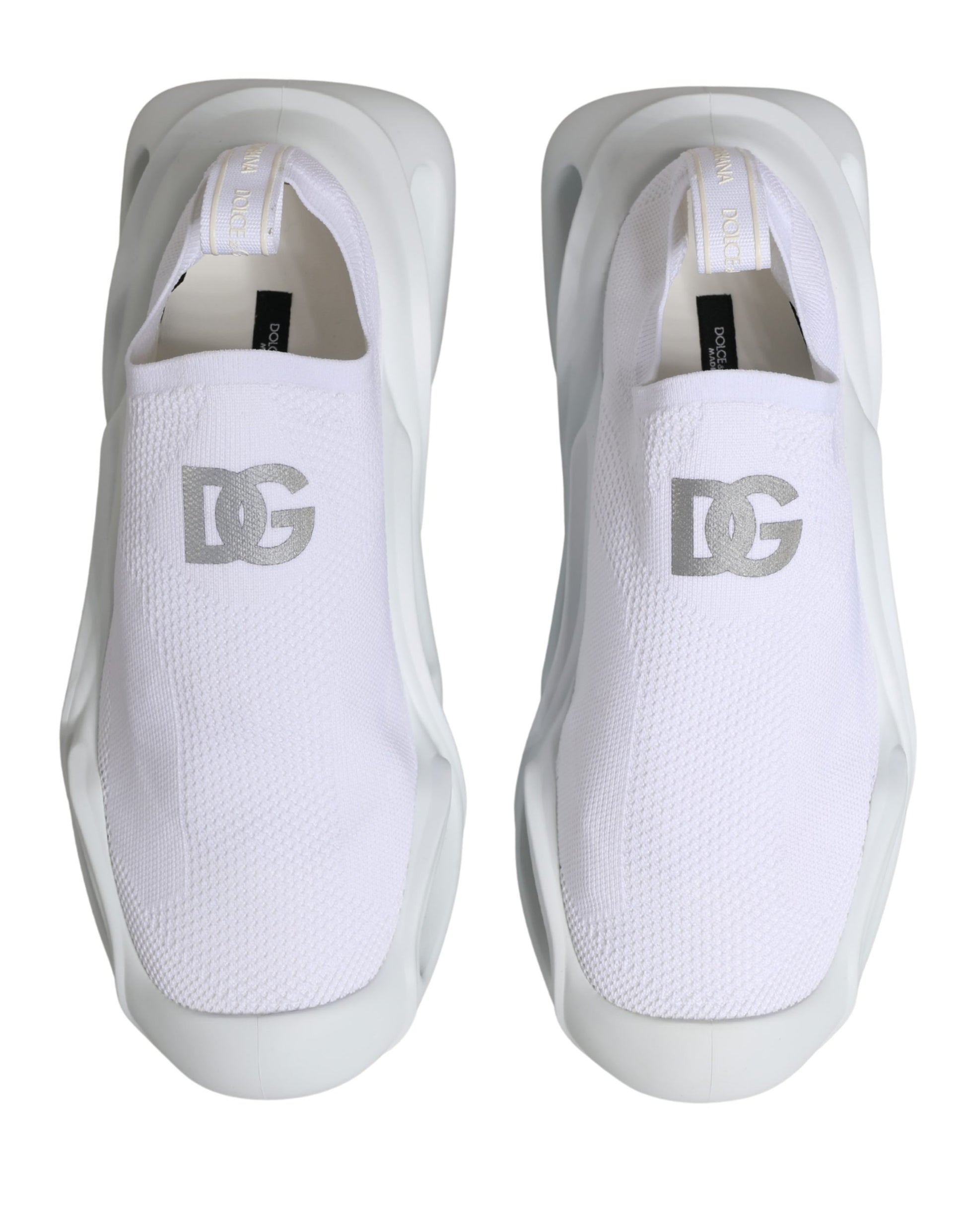 Pair of white slip-on shoes with brand logo on side