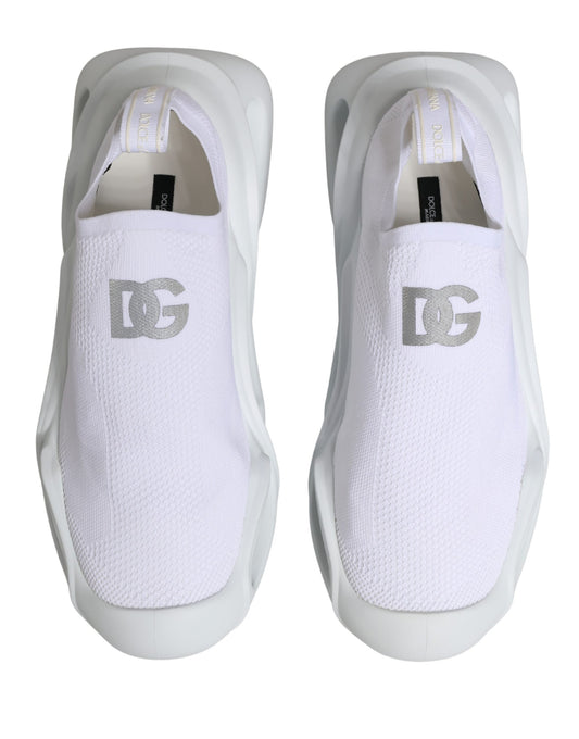 Pair of white slip-on shoes with brand logo on side