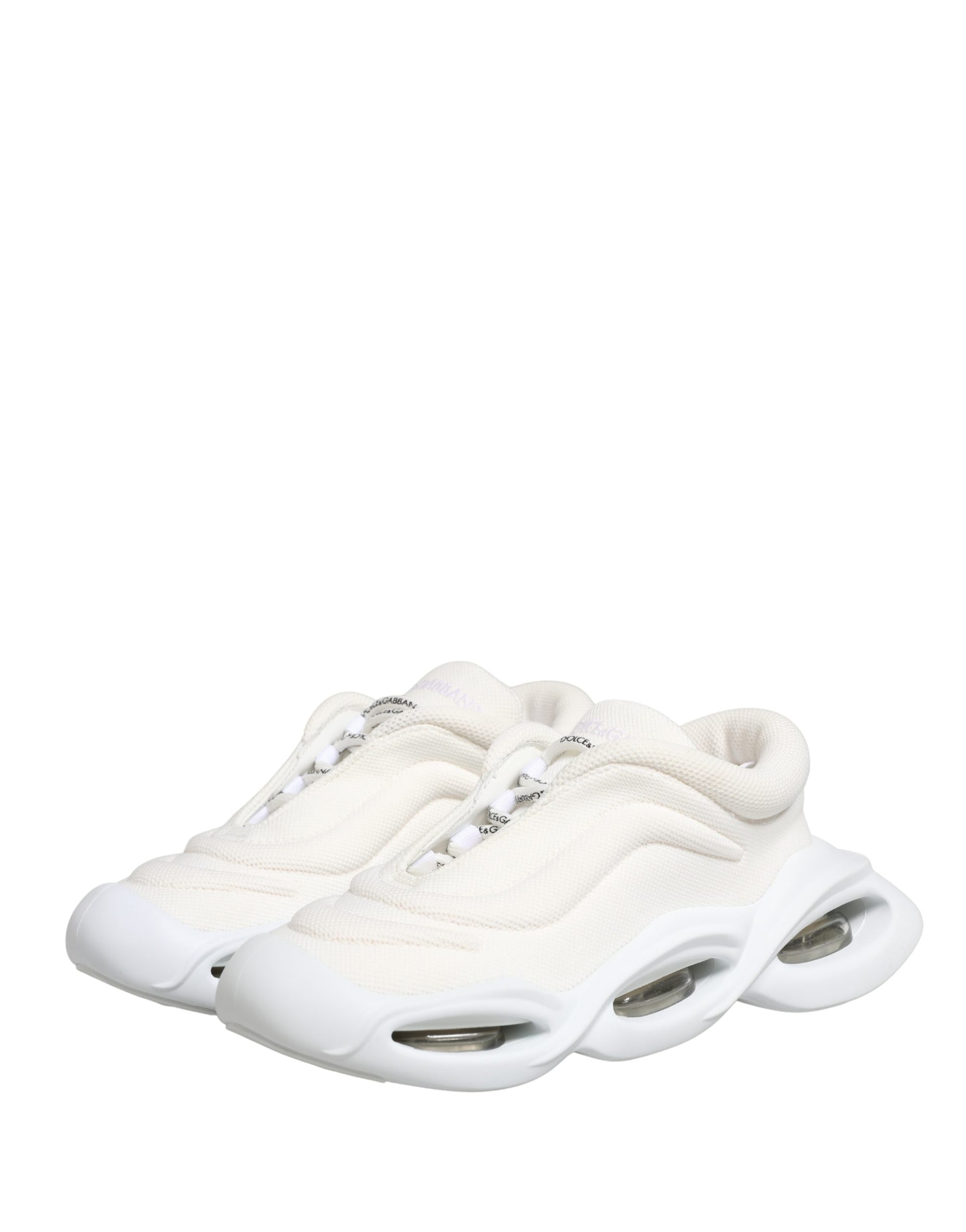A pair of white slip-on shoes with a low top, featuring a wave design on the side
