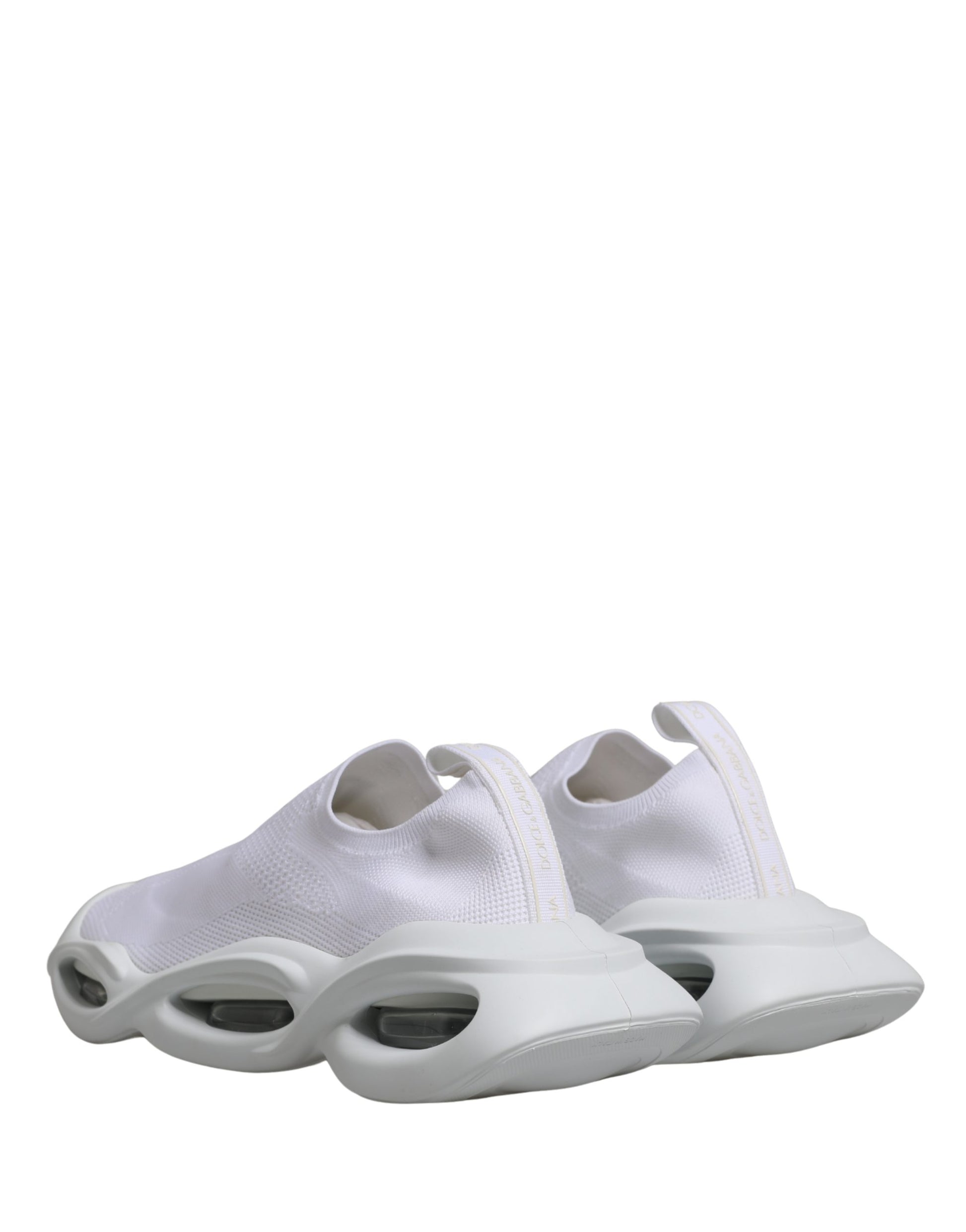 Pair of white slip-on shoes with a low top, featuring a wave design on the side