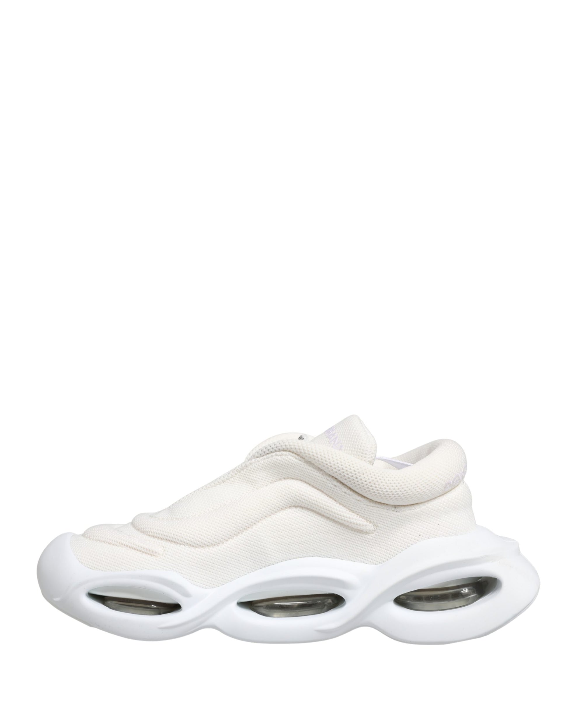 White slip-on shoes with wave design on soles, featuring a low top and a textured upper