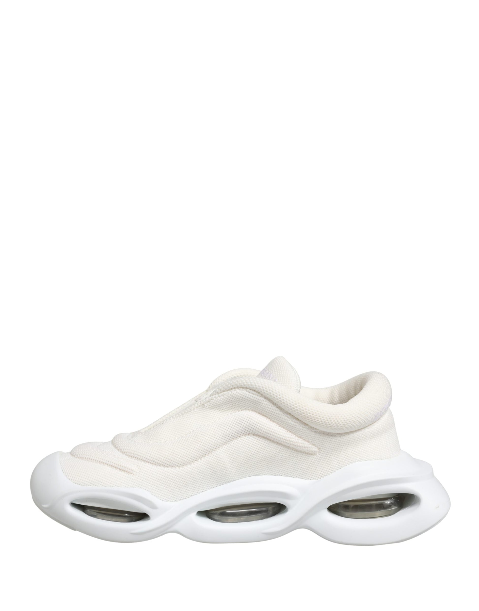 A pair of white slip-on shoes with a textured upper and a low top design