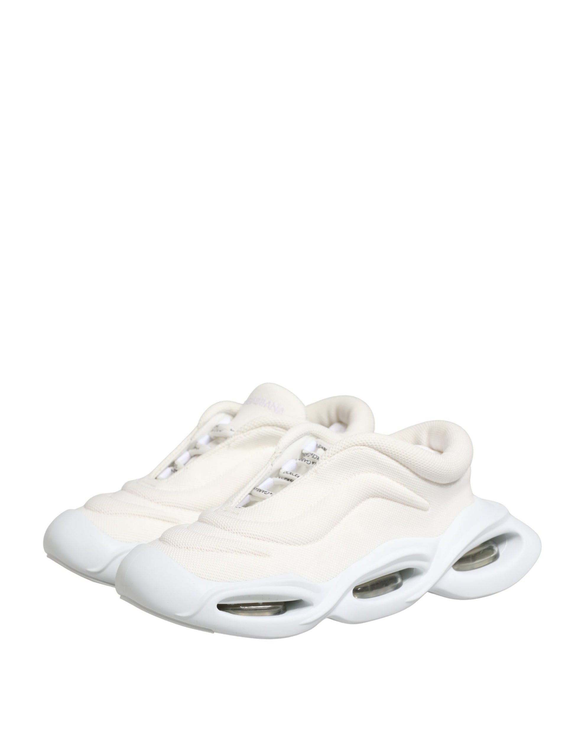 A pair of white slip-on shoes with a low top, featuring a wave design on the side