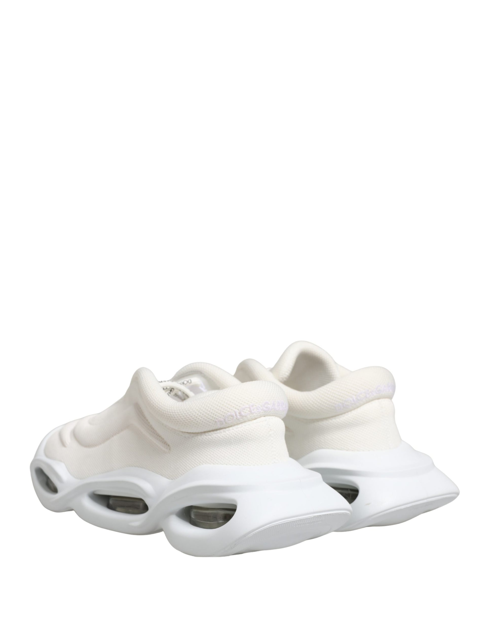 Pair of white slip-on shoes with low top, featuring a wave design on the side