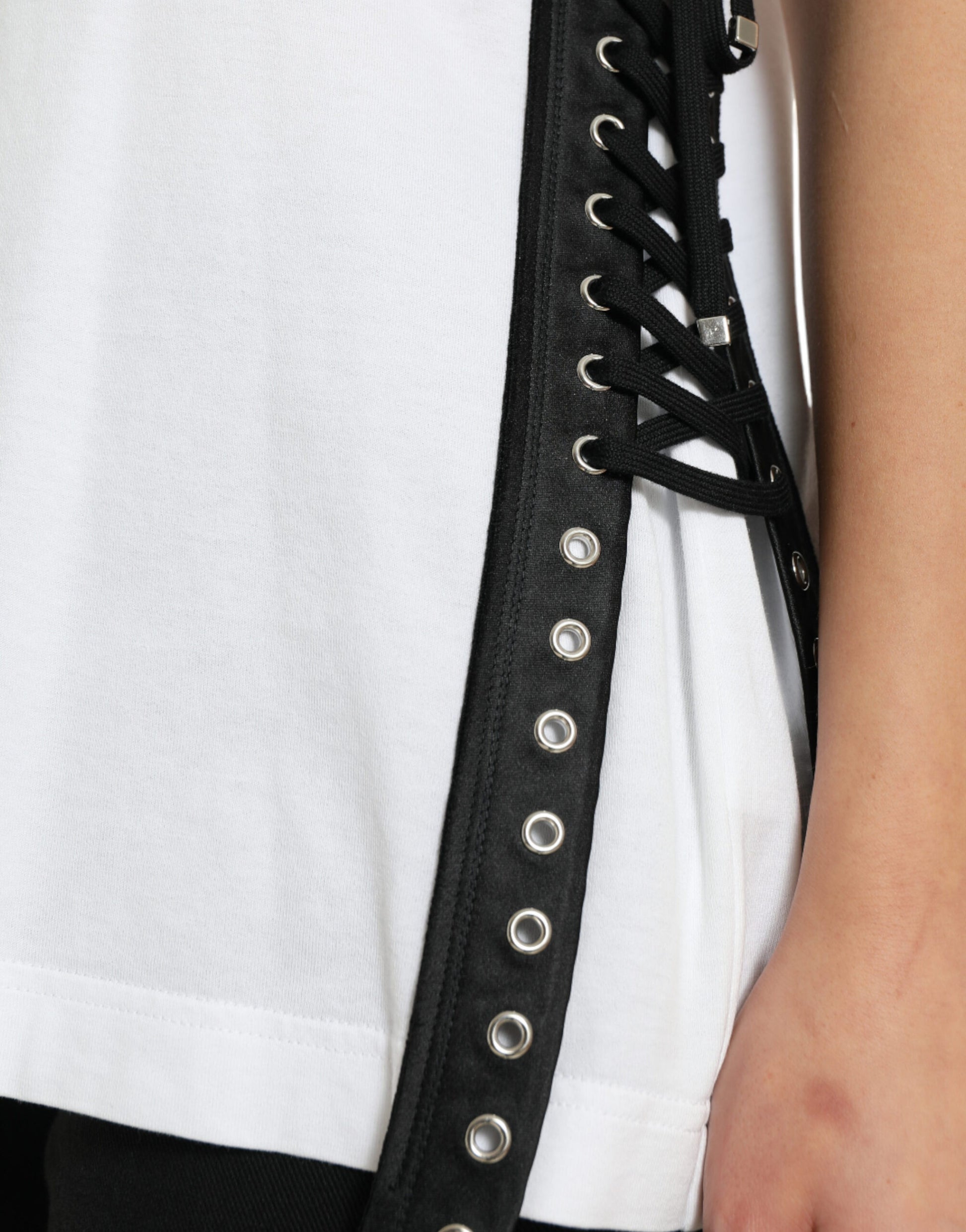 Black leather corset with silver studs on a white shirt