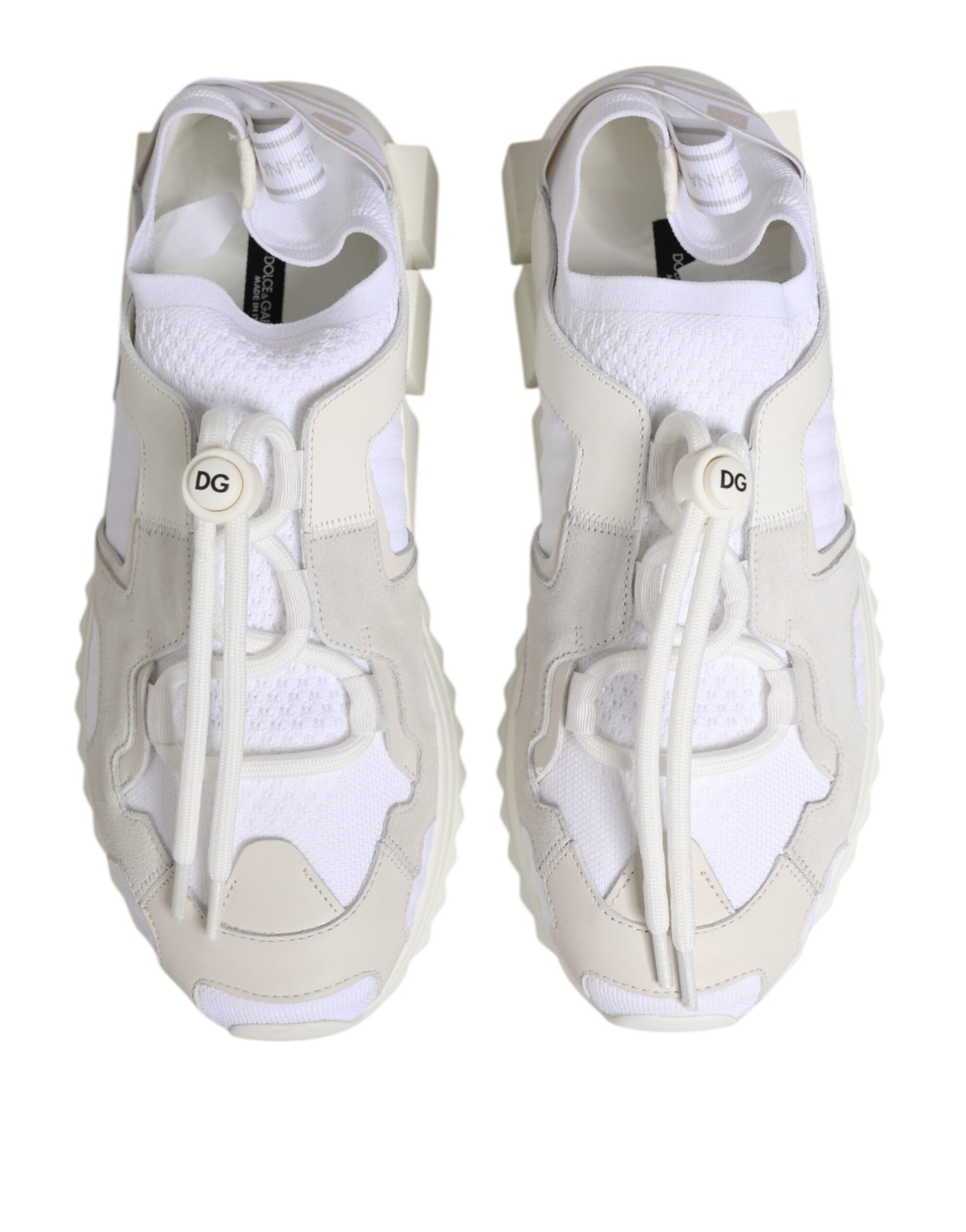 Pair of white lace-up sneakers with a low top and a logo on the side