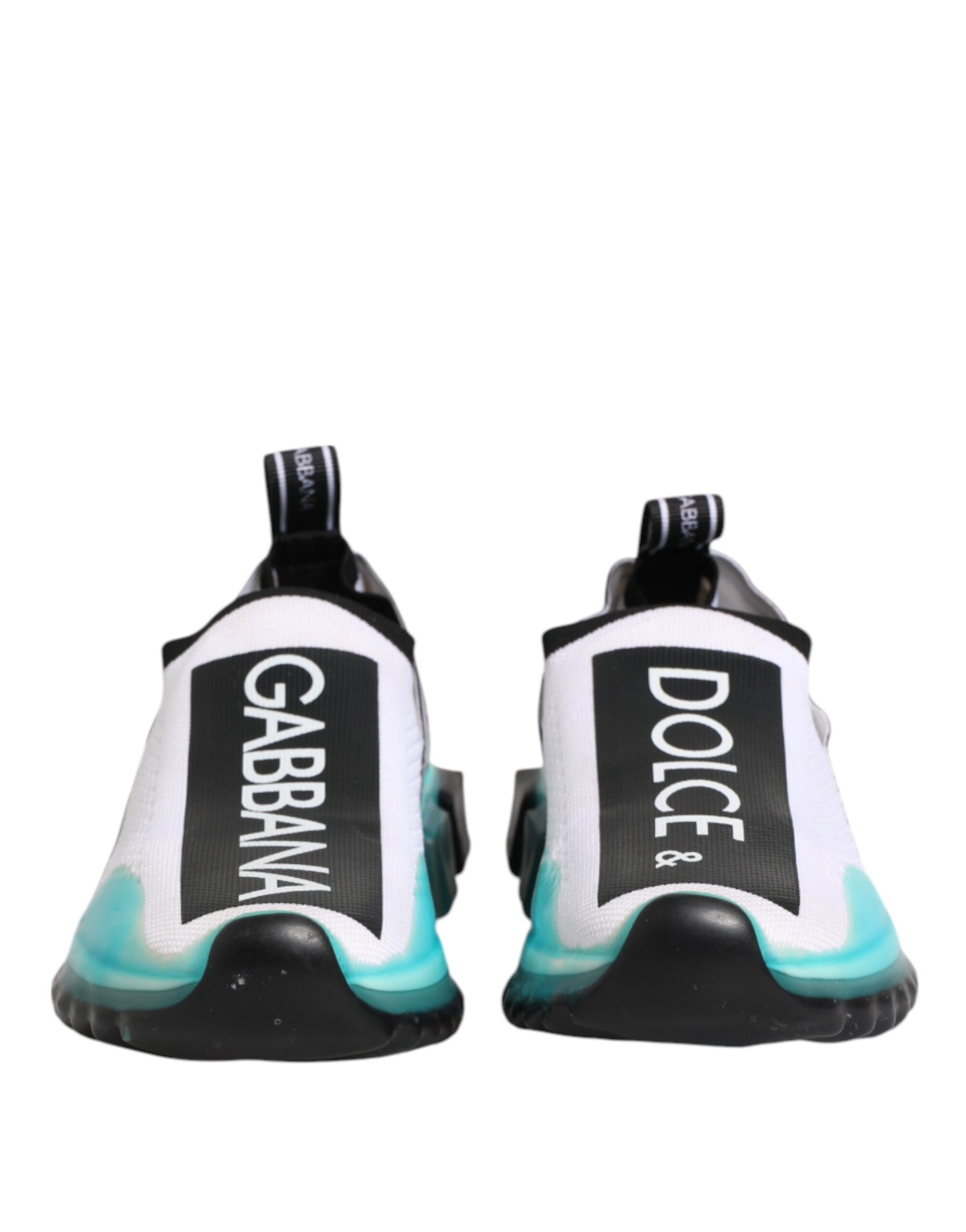 Pair of white slip-on shoes with black and green accents, featuring the Dolce & Gabbana logo