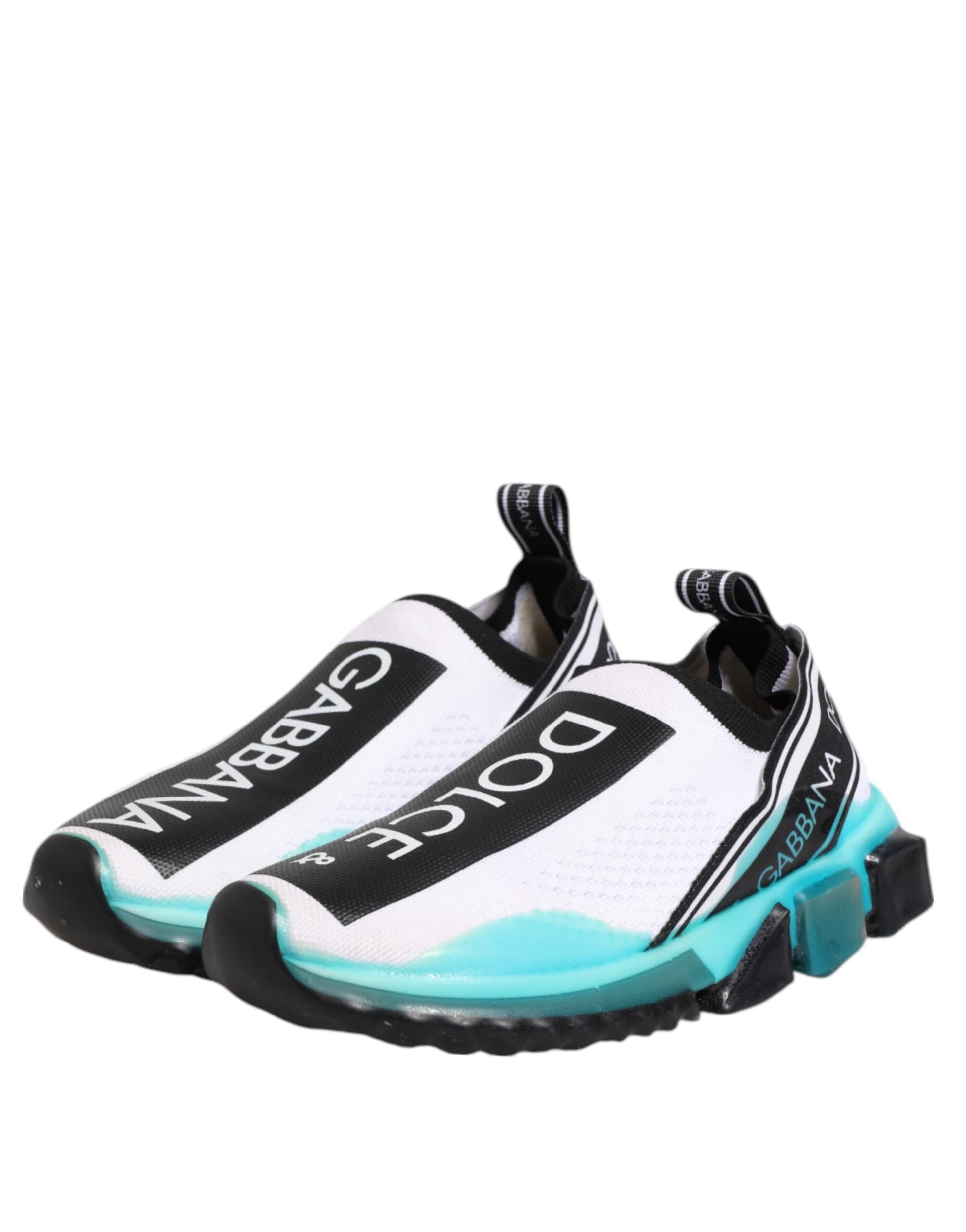 A pair of white slip-on shoes with blue accents, featuring the brand name "Dolce & Gabbana" and the word "Sorrento