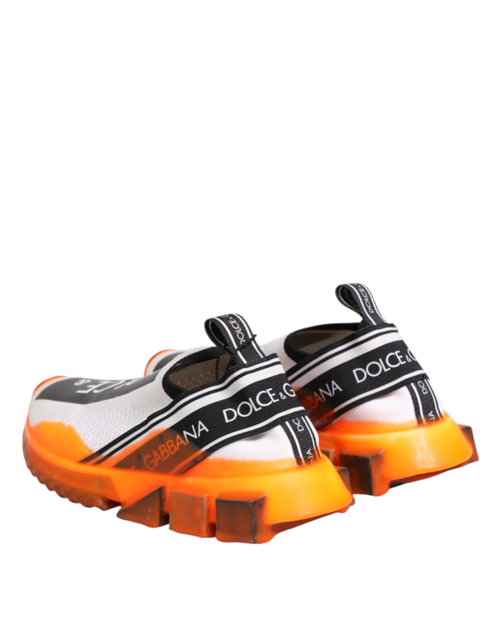 Orange and white slip-on shoes with black straps, featuring the Dolce & Gabbana logo