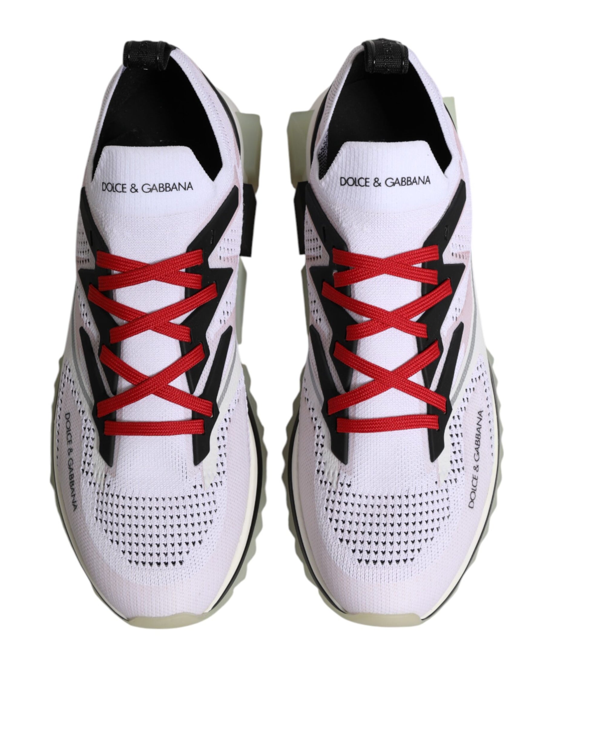 Pair of white sneakers with red laces and logo on side, designed by Dolce & Gabbana