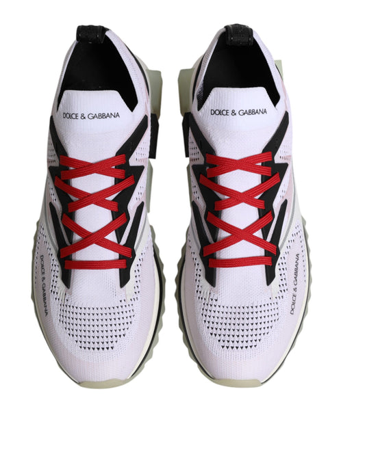 Pair of white sneakers with red laces and logo on side, designed by Dolce & Gabbana
