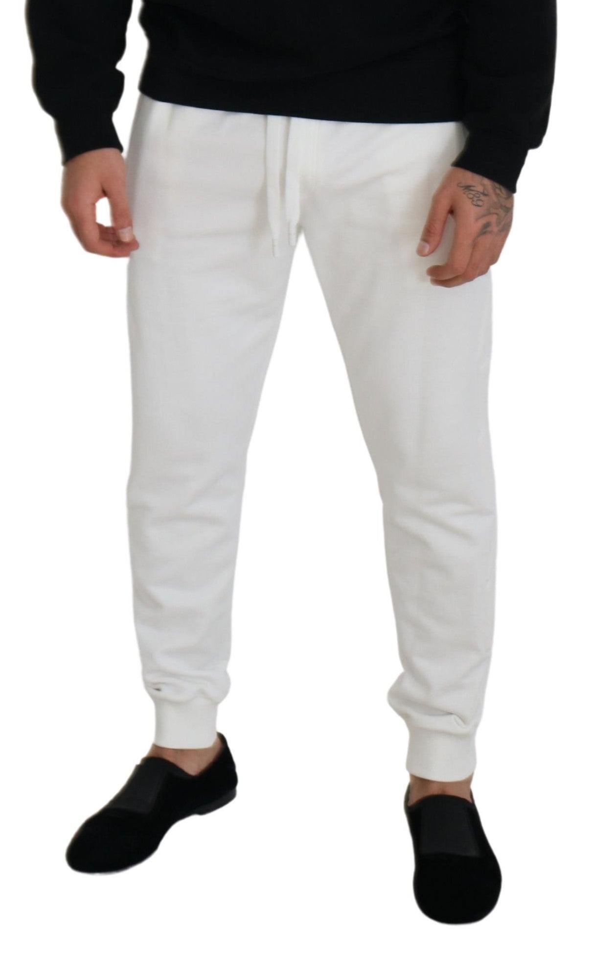 Man wearing white sweatpants and black shoes