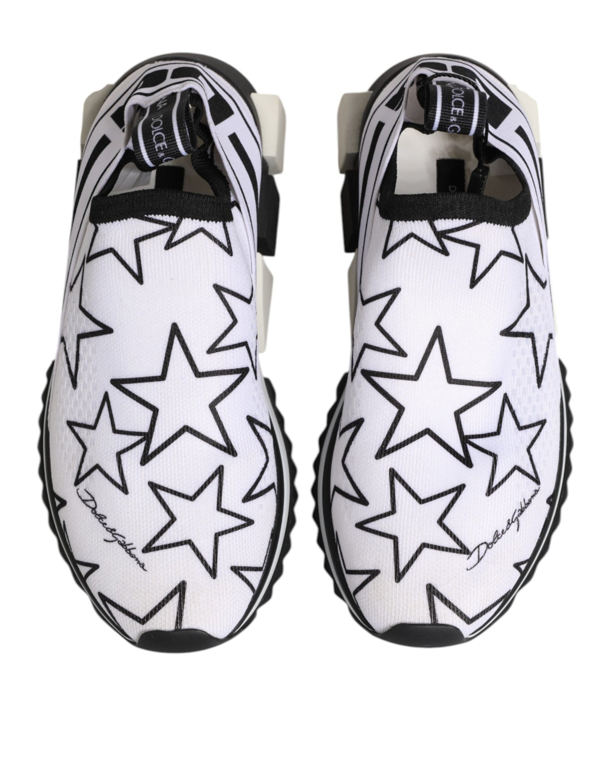 Pair of white sneakers with black stars, featuring a low top and a chunky sole