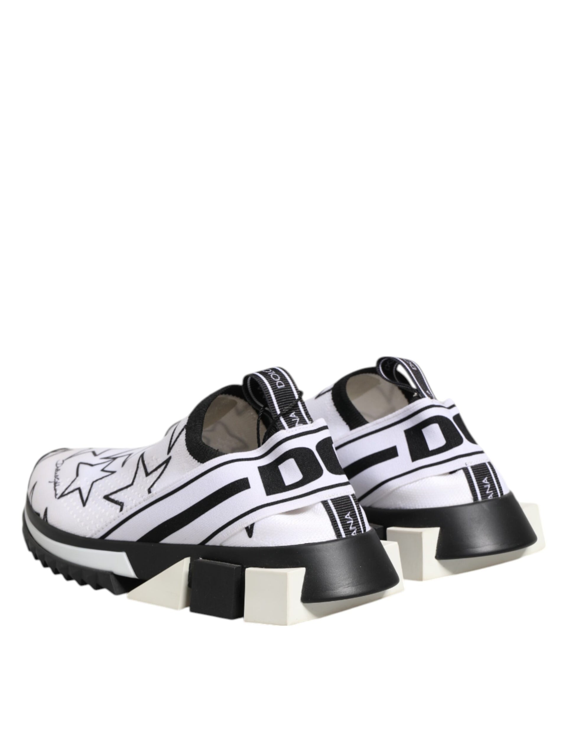 A pair of white sneakers with black stars, featuring a low top design and chunky soles