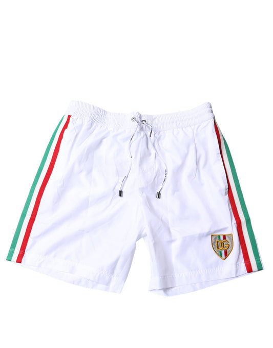 White swim shorts with red and green stripes, featuring a logo on the left leg