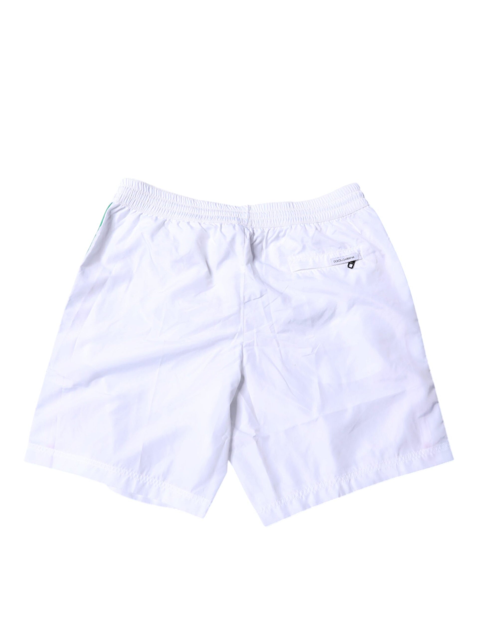 White beach shorts with stripe detailing, part of a two-piece swimwear set