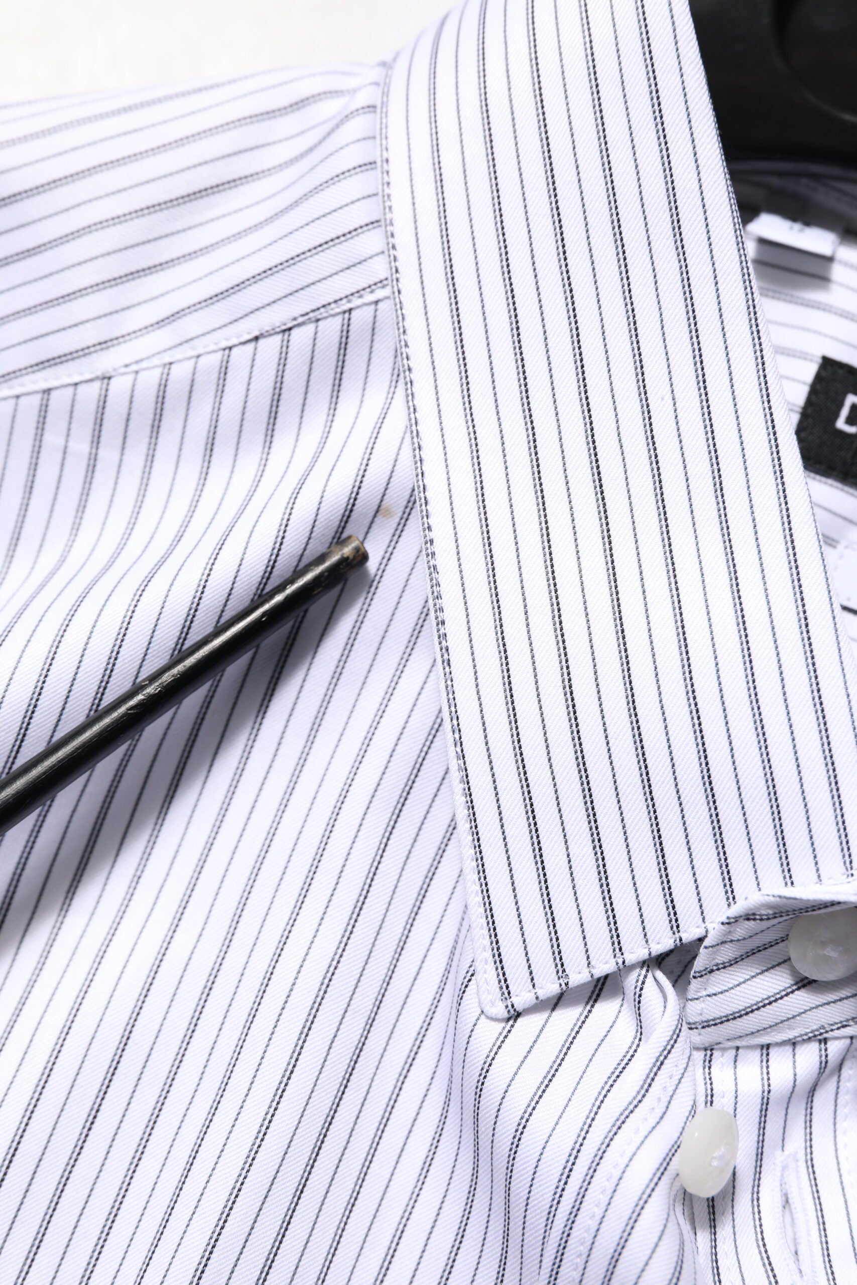 A white dress shirt with gold stripes, designed by Dolce & Gabbana
