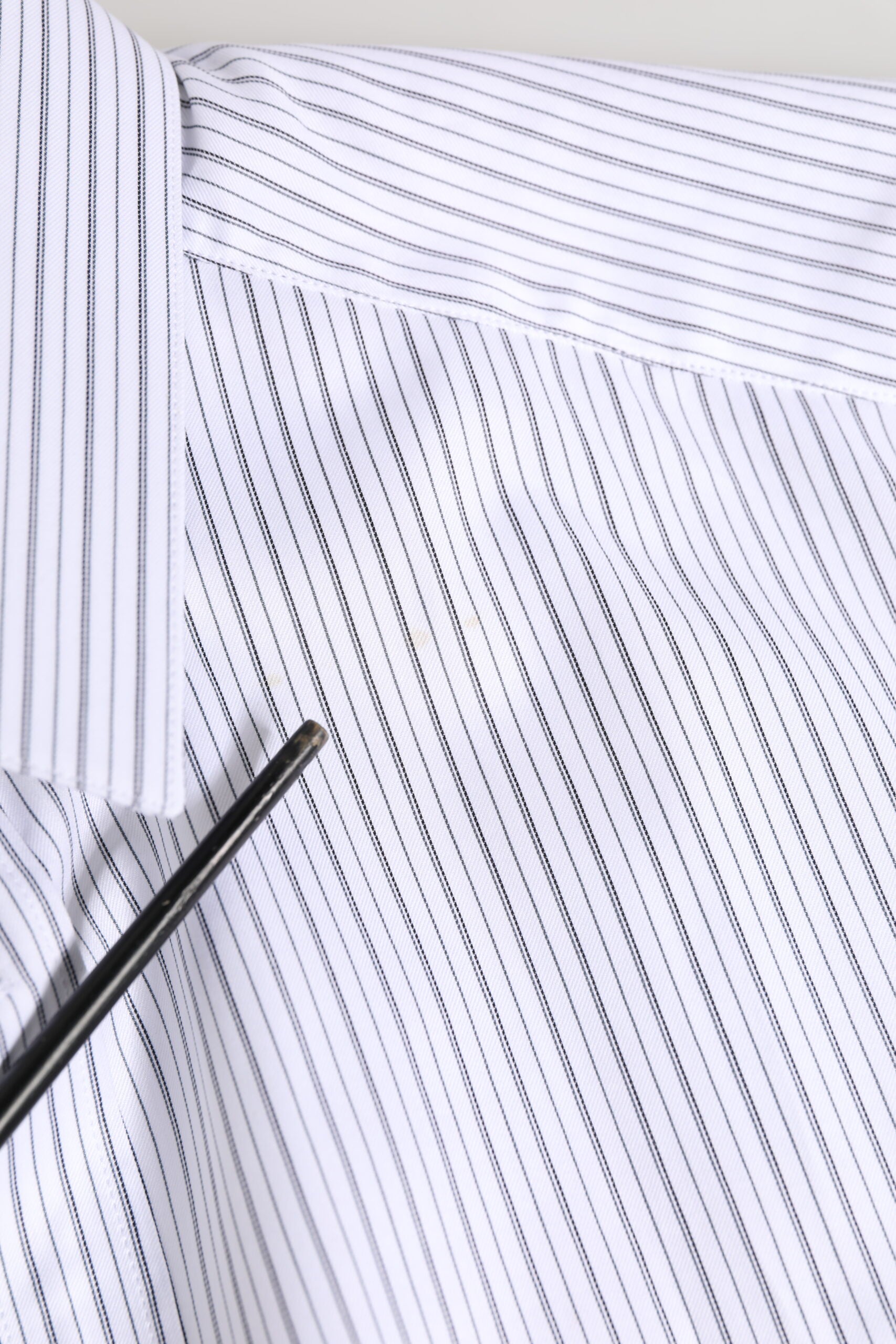 A white dress shirt with gold stripes, designed by Dolce & Gabbana