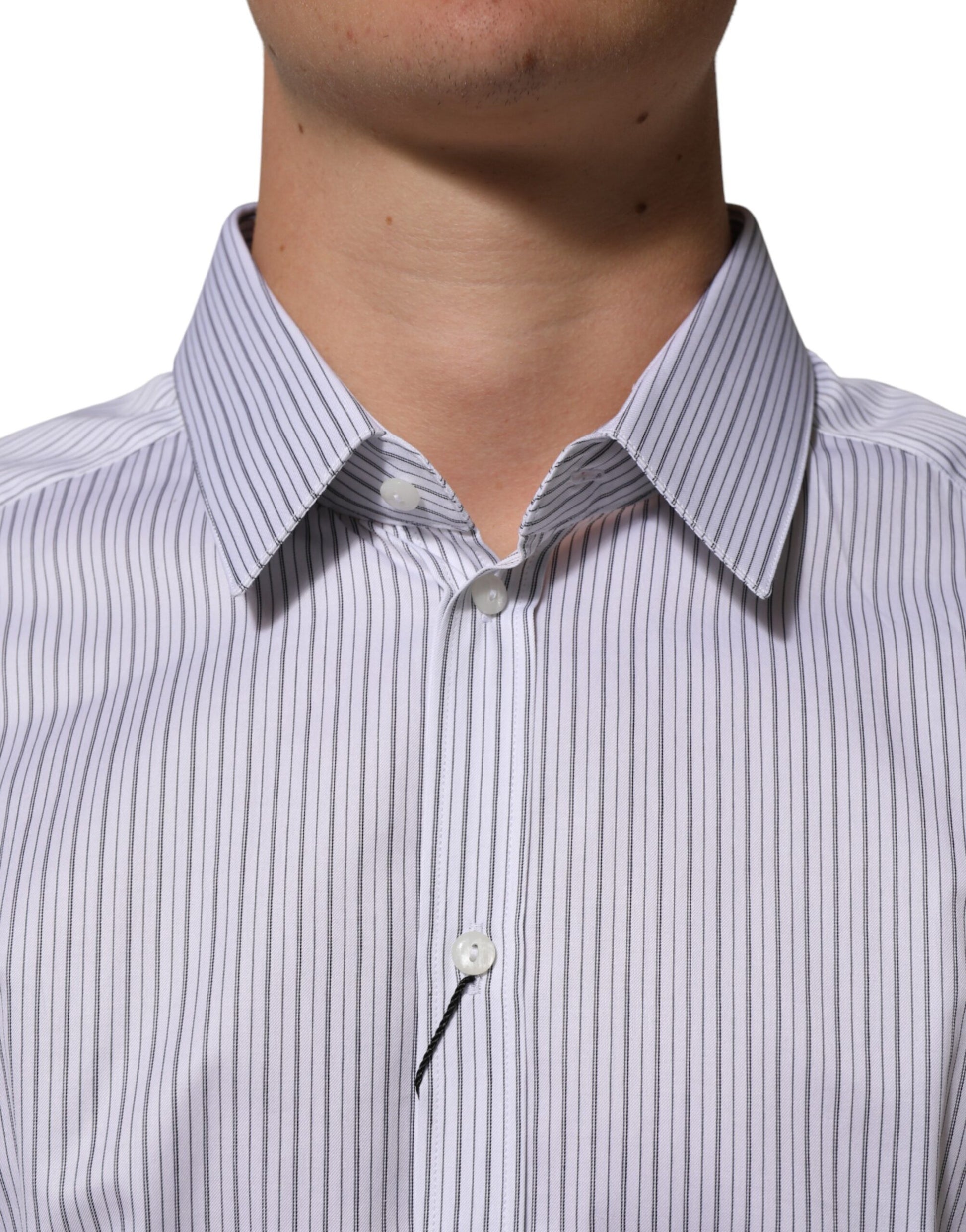 A long sleeve dress shirt with white stripes and a gold button