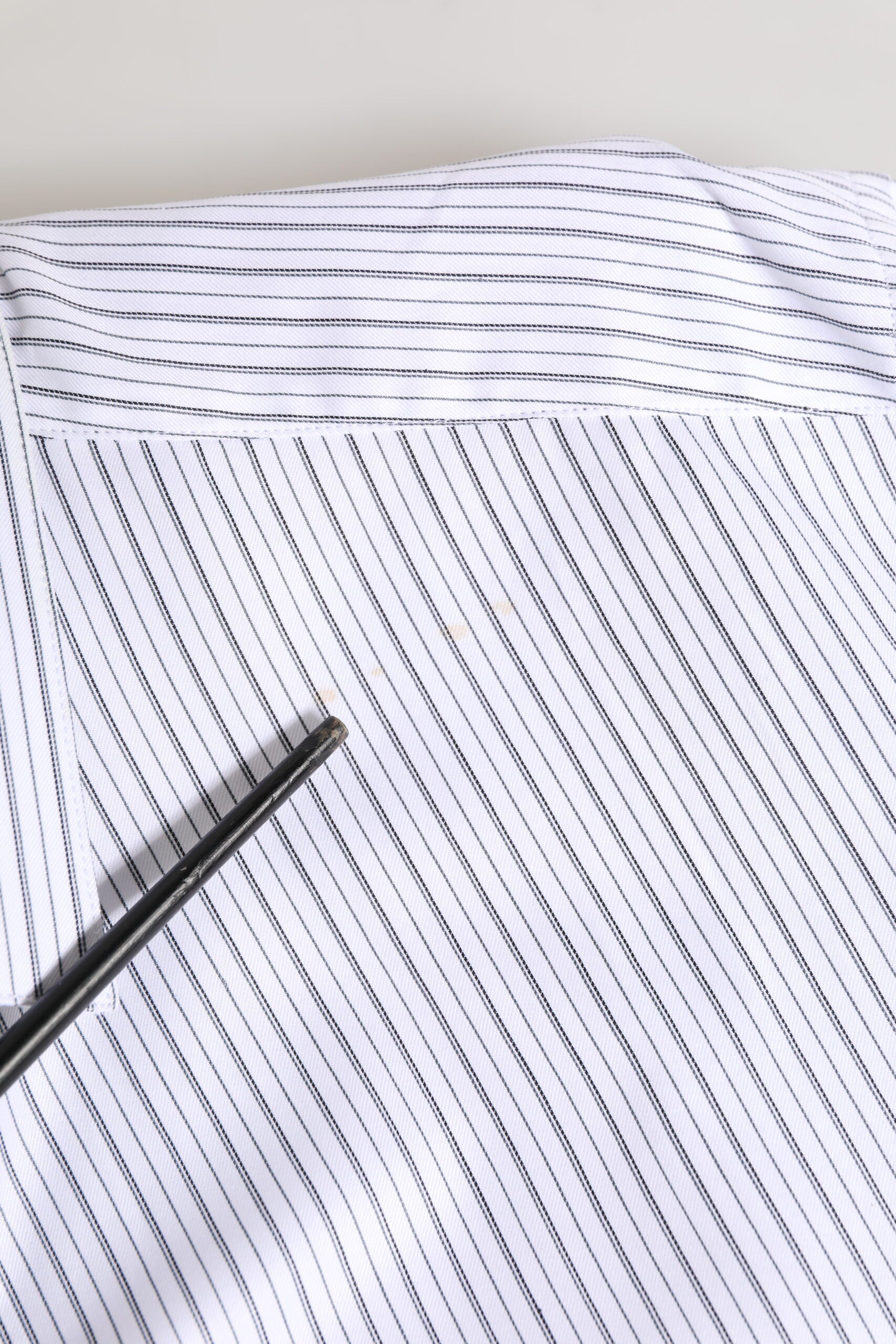 A white long sleeve dress shirt with gold stripes, designed by Dolce & Gabbana