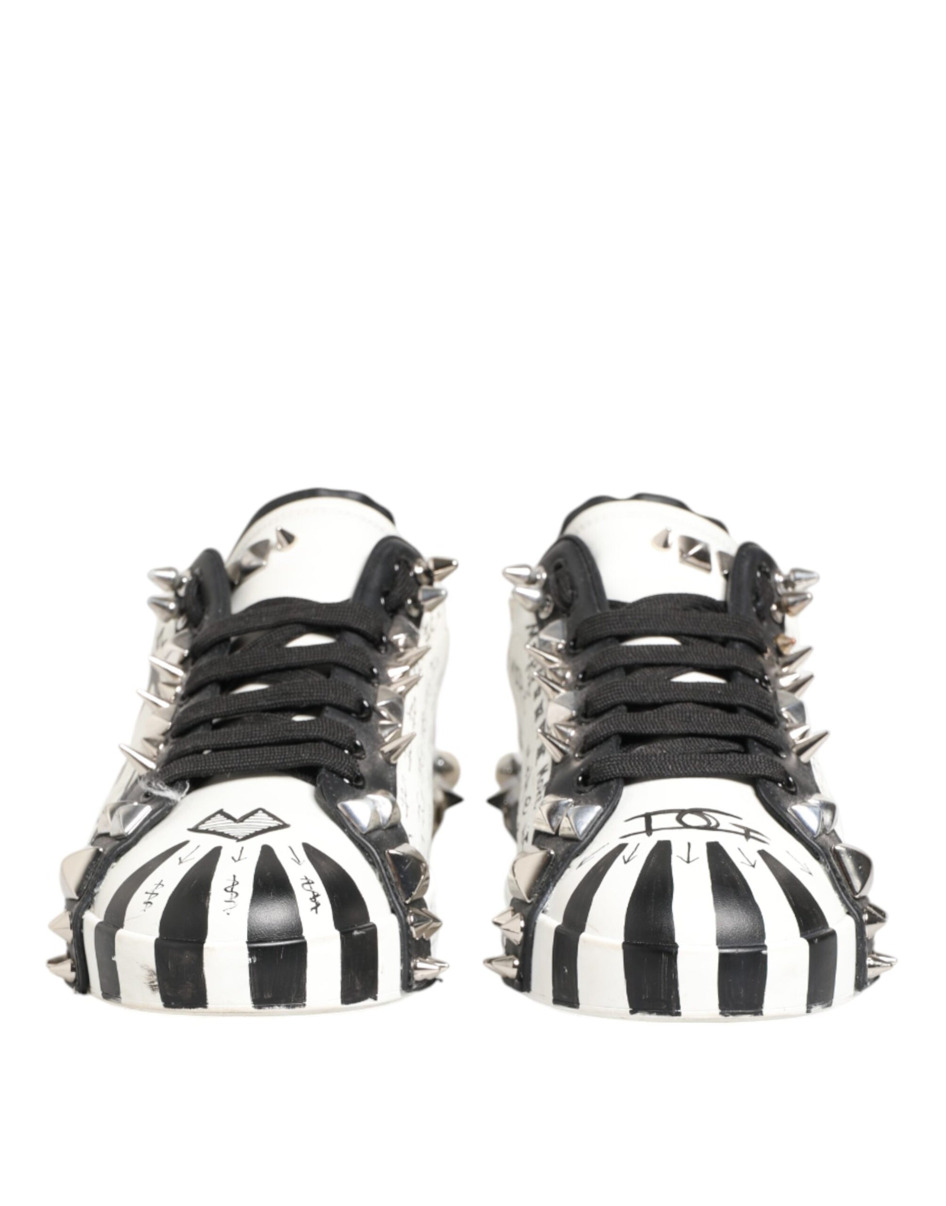 Black and white sneakers with studs, featuring a print design