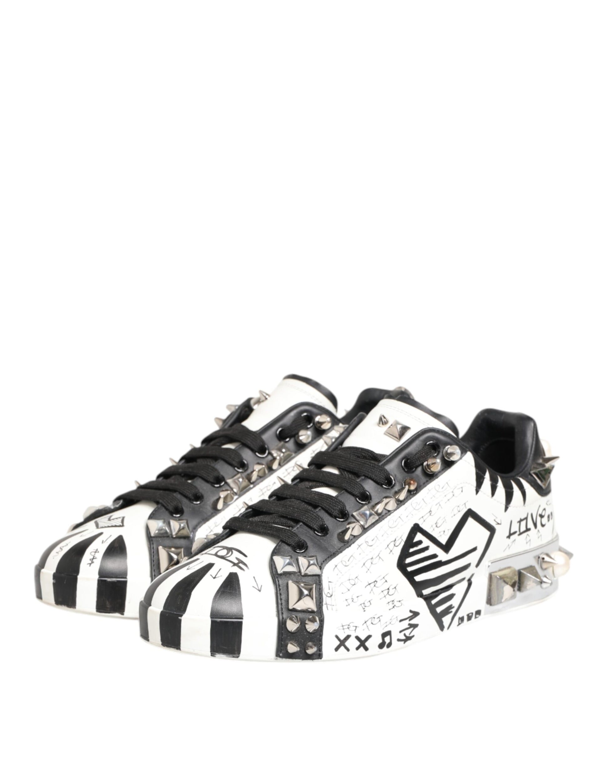 Black and white sneakers with studs, featuring a printed design on the side