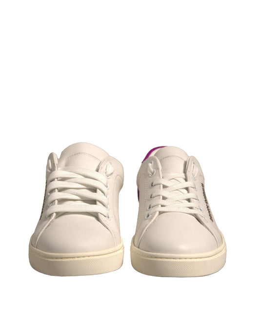 Pair of white sneakers with pink laces