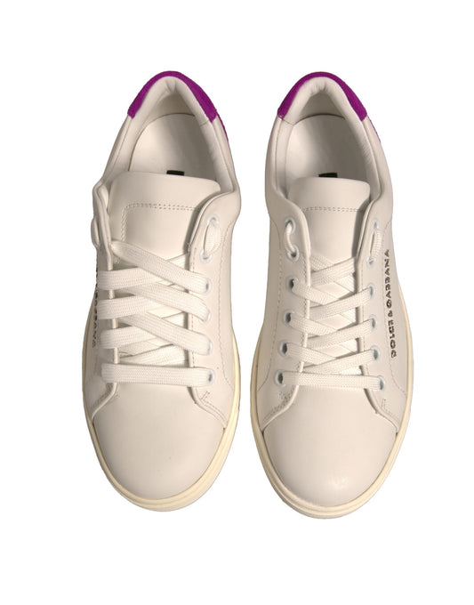 Pair of white sneakers with purple laces