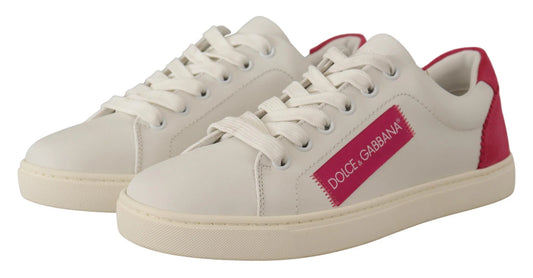Pair of white suede leather low top sneakers with red accents and brand name on side
