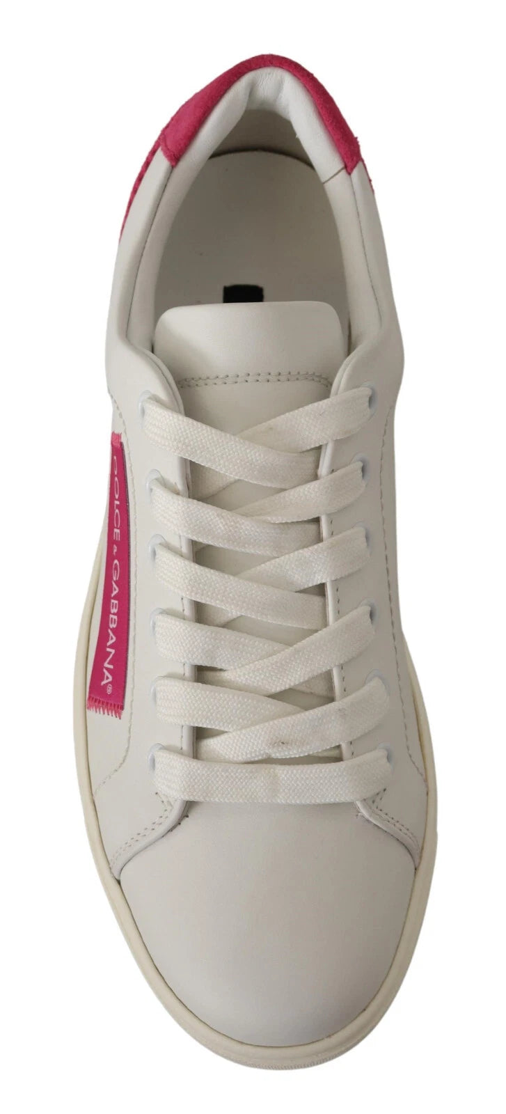A pair of white suede leather low top sneakers with red accents and a logo on the side