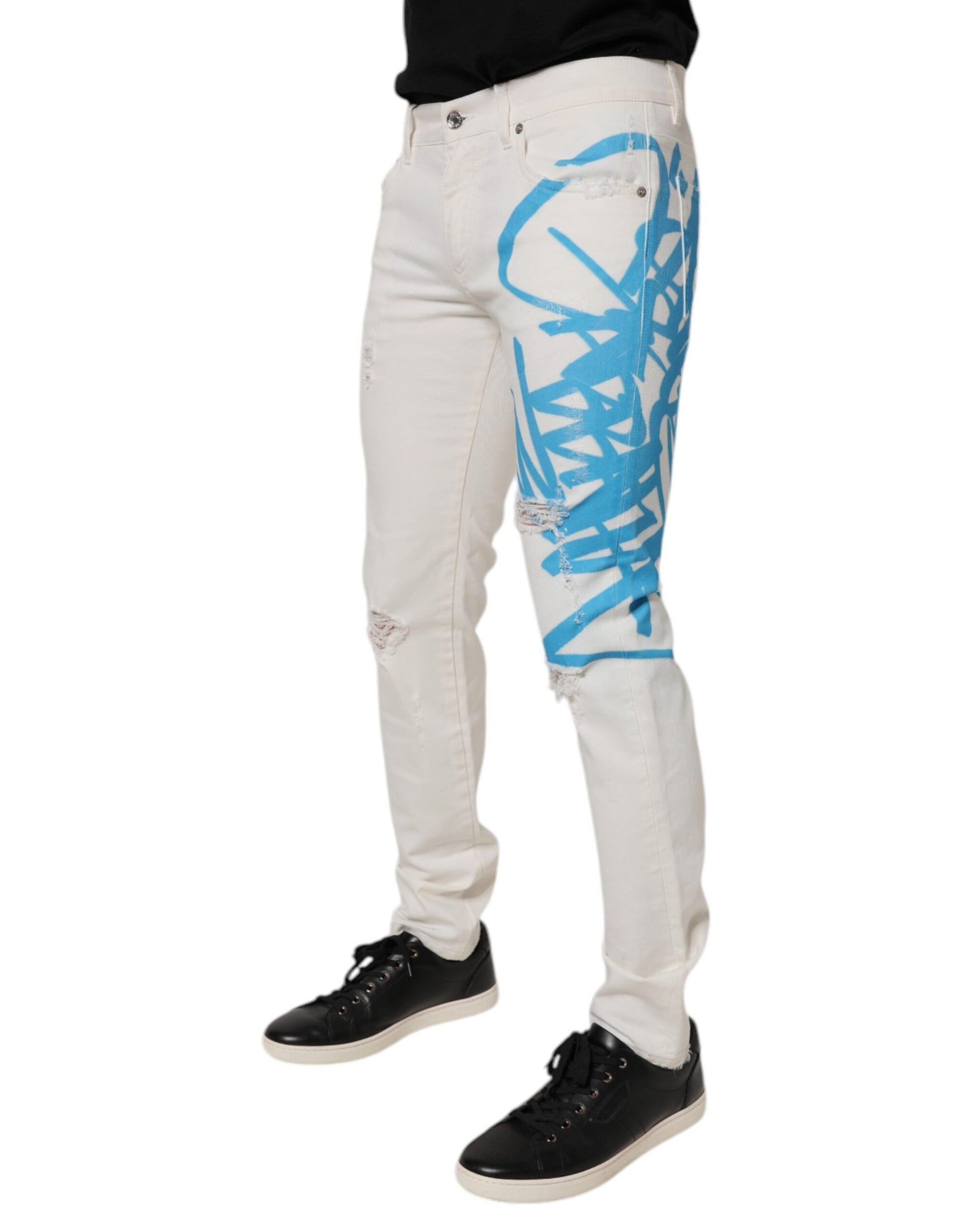Pair of distressed jeans with blue design on legs