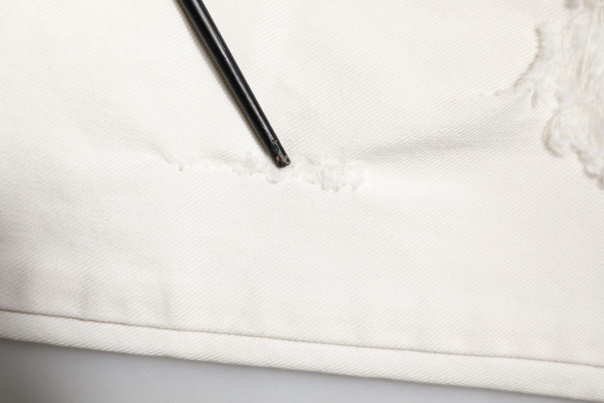 Black zipper on white fabric