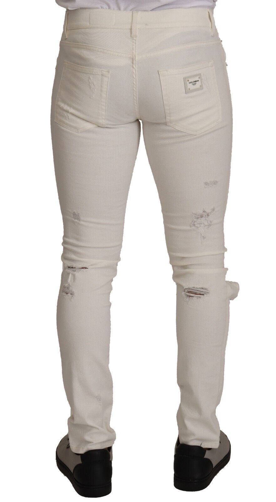 Pair of light wash denim jeans with distressed areas on thighs