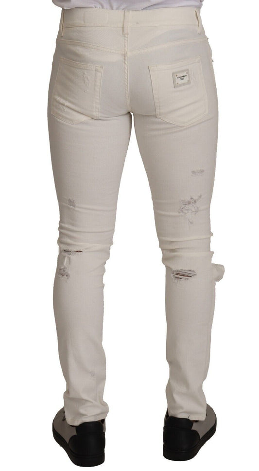 Pair of light wash denim jeans with distressed areas on thighs