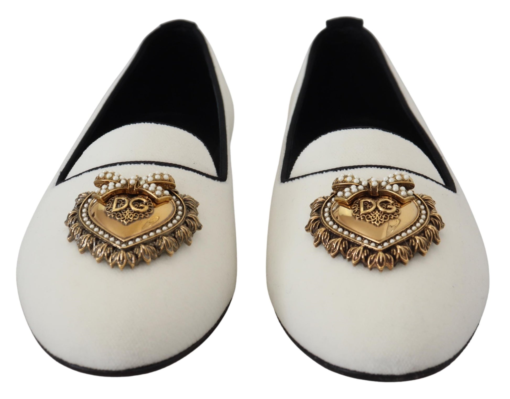 Pair of white shoes with gold embellishments and a heart design on the toe cap