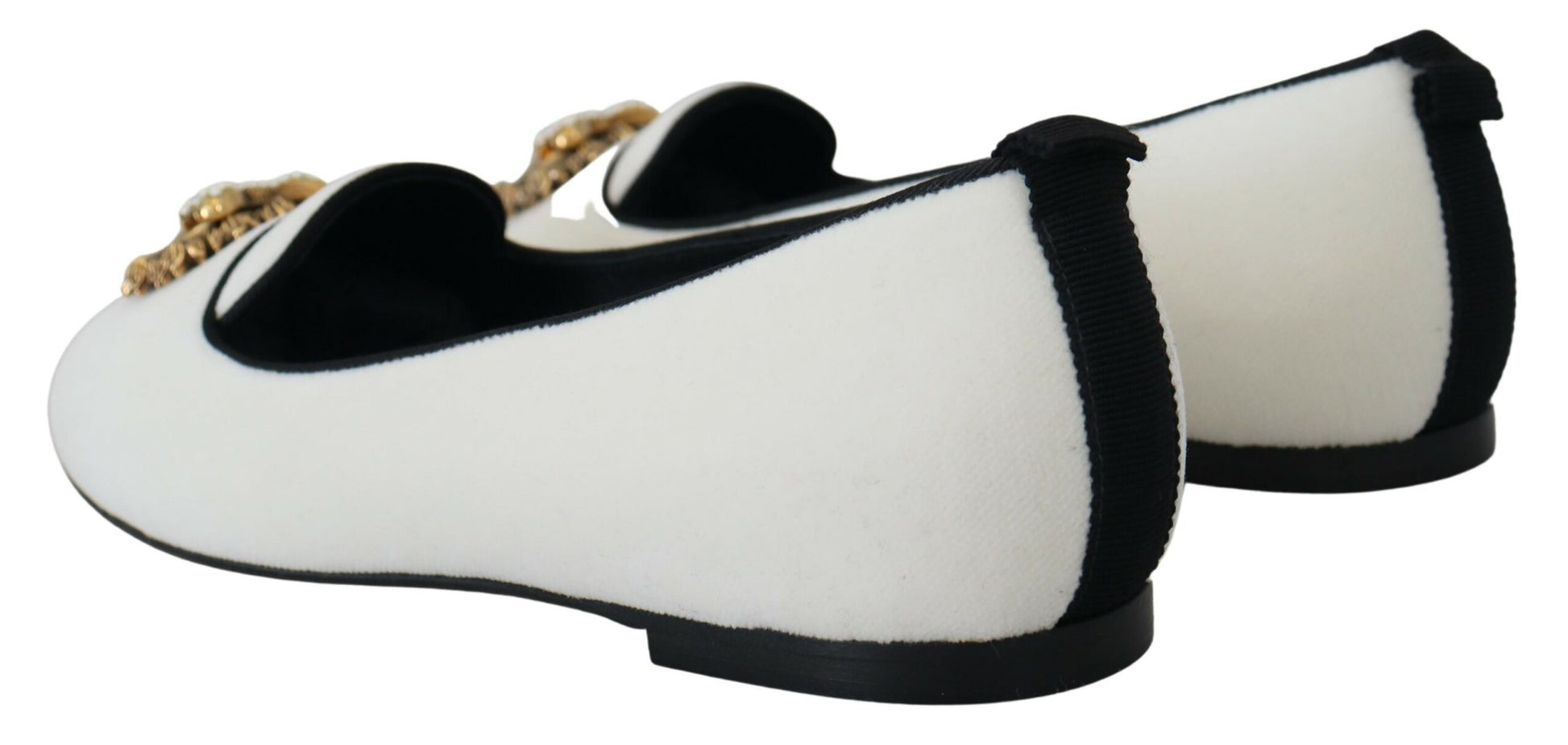 Pair of black and white furry shoes with gold accents