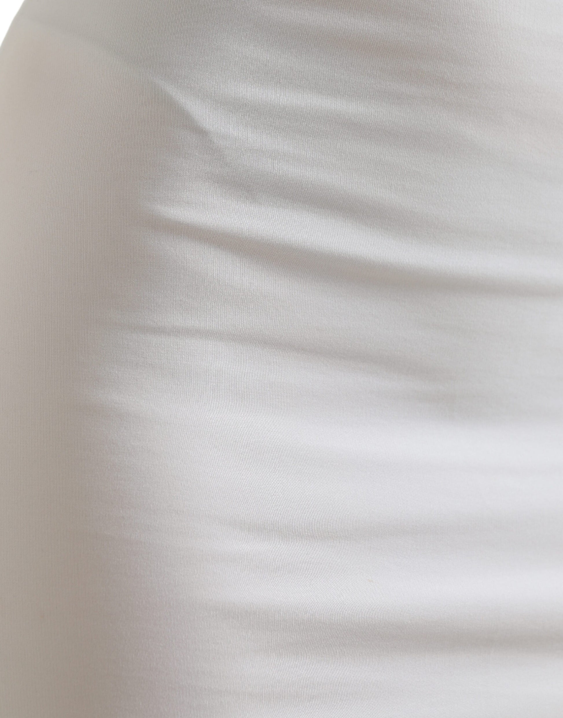 A close-up view of a white garment, possibly a dress or skirt, with a textured fabric that appears to be knit