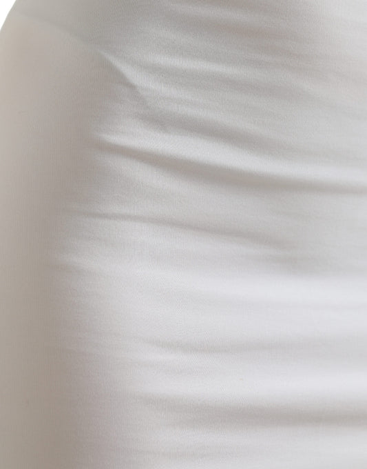 A close-up view of a white garment, possibly a dress or skirt, with a textured fabric that appears to be knit
